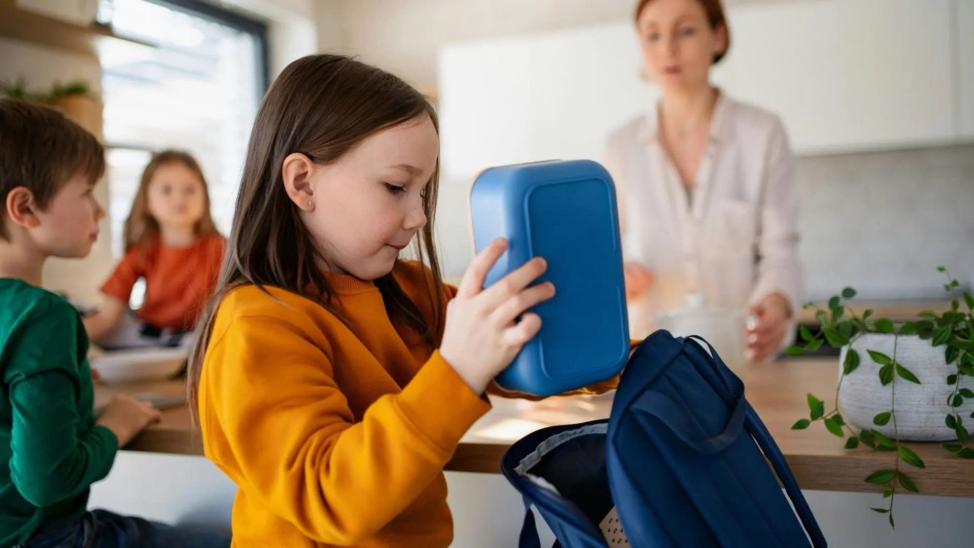 kid in class with lunchbox
