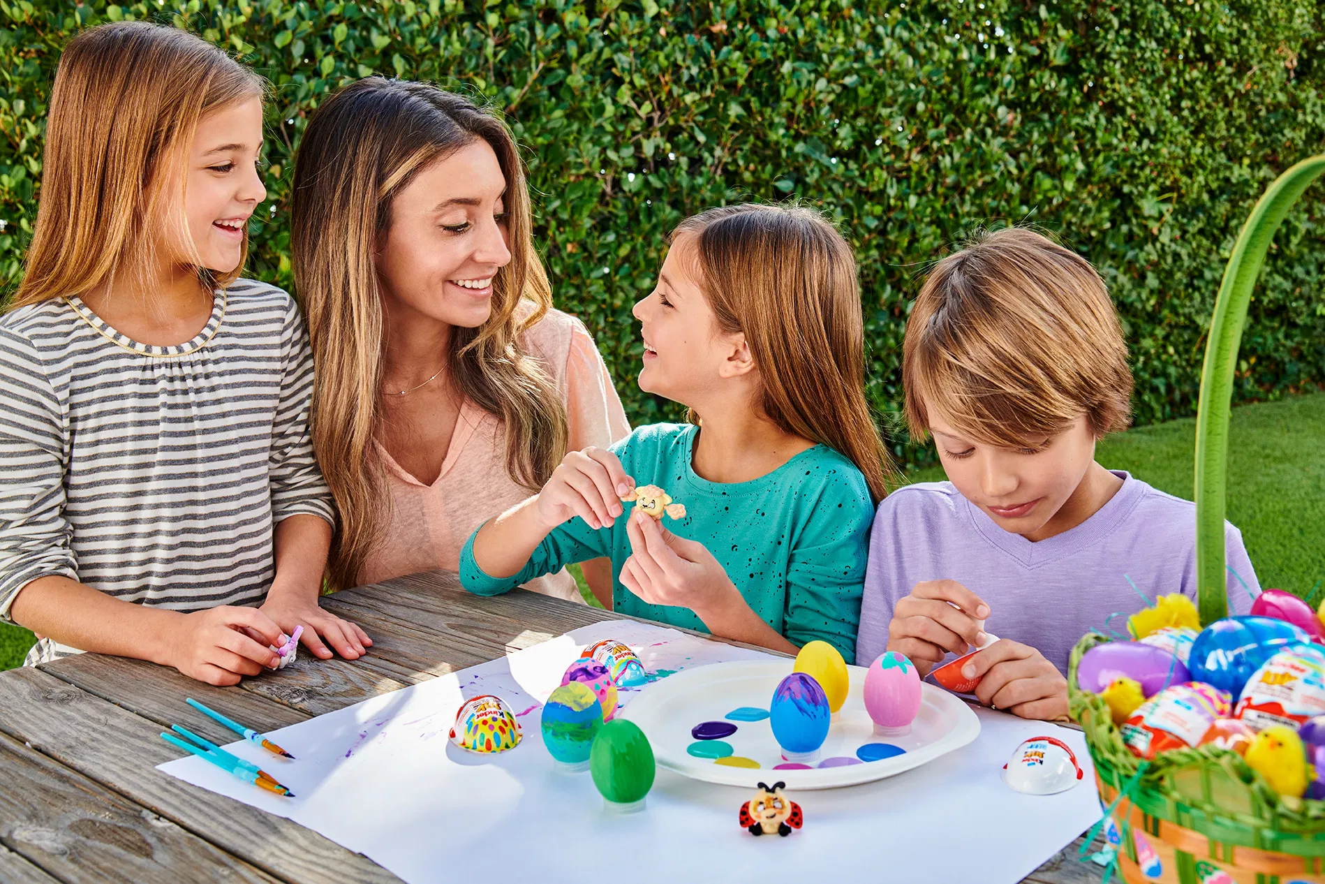 mom and children coloring easter eggs